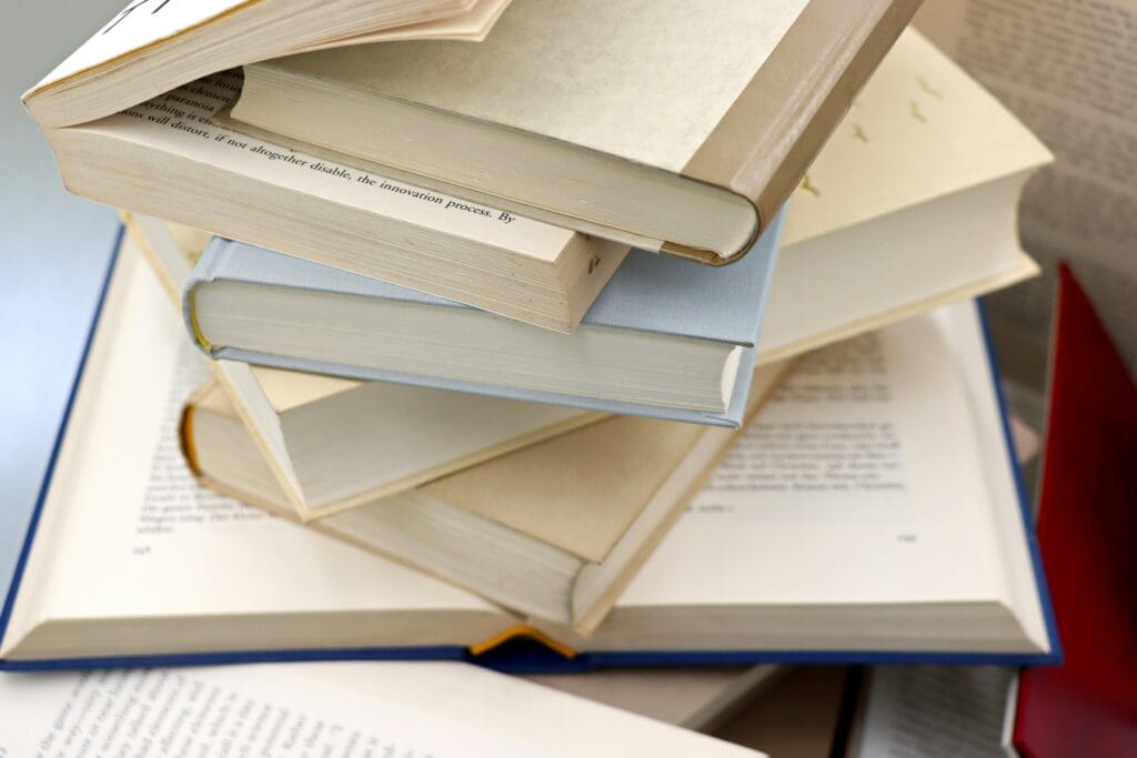 pexels photo 32063096 32063096 A disorganized stack of open and closed books showcasing education and study themes.